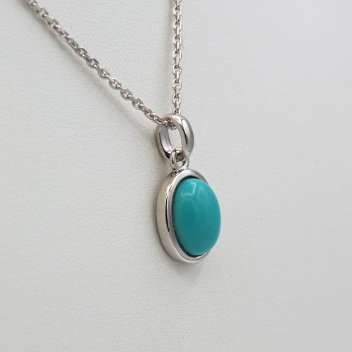 Modern rhodium-plated silver pendant with oval turquoise