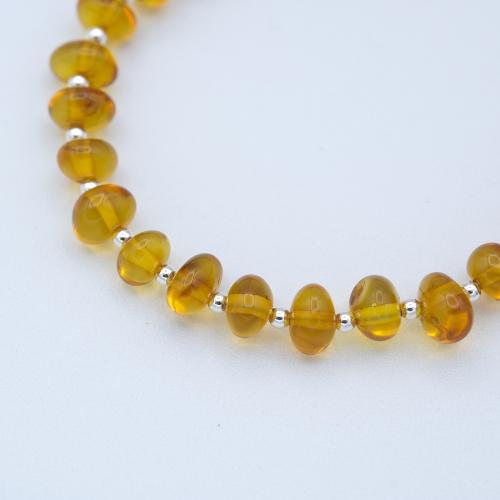 Semi-rigid amber bracelet with round beads